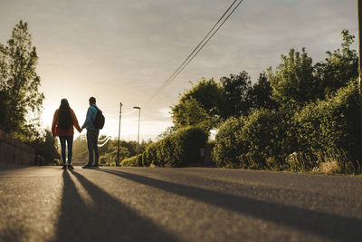 Couple of hikers standing on road
