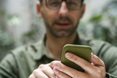 Portrait of man using mobile phone outdoors