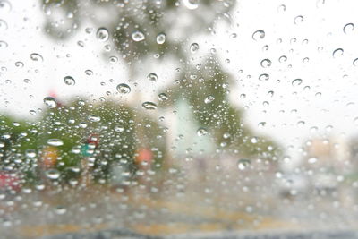 Full frame shot of wet glass window in rainy season