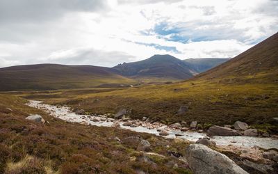 Scenic view of mountains against cloudy sky