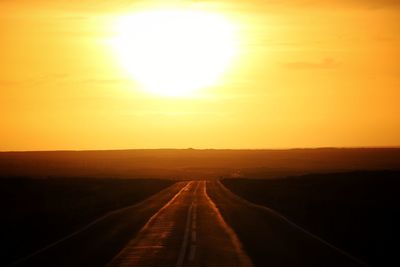 Road amidst landscape against sky during sunset