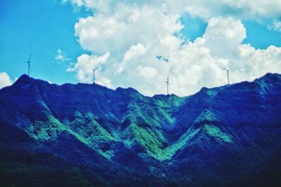 Scenic view of mountains against cloudy sky