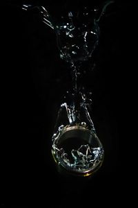 Close-up of water splashing against black background