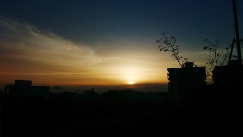 Silhouette built structures at sunset