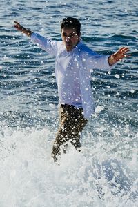 Young man swimming in sea