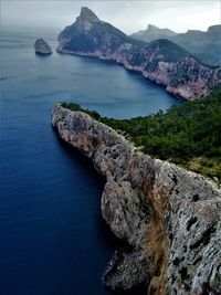 High angle view of rocks on sea against sky