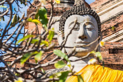 Statue of buddha against building