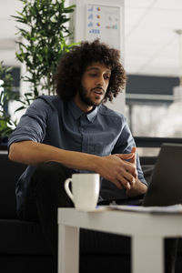 Young woman using laptop at home