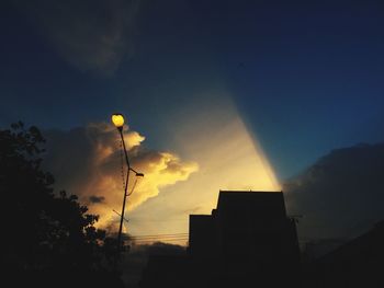 Low angle view of silhouette buildings against sky at sunset