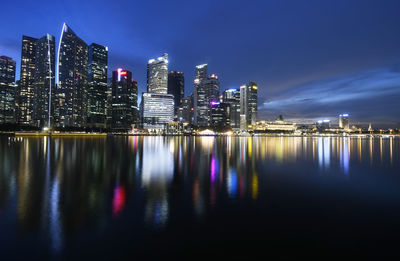 Reflection of illuminated buildings in city at night