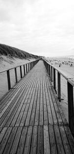 Wooden pier leading to sea