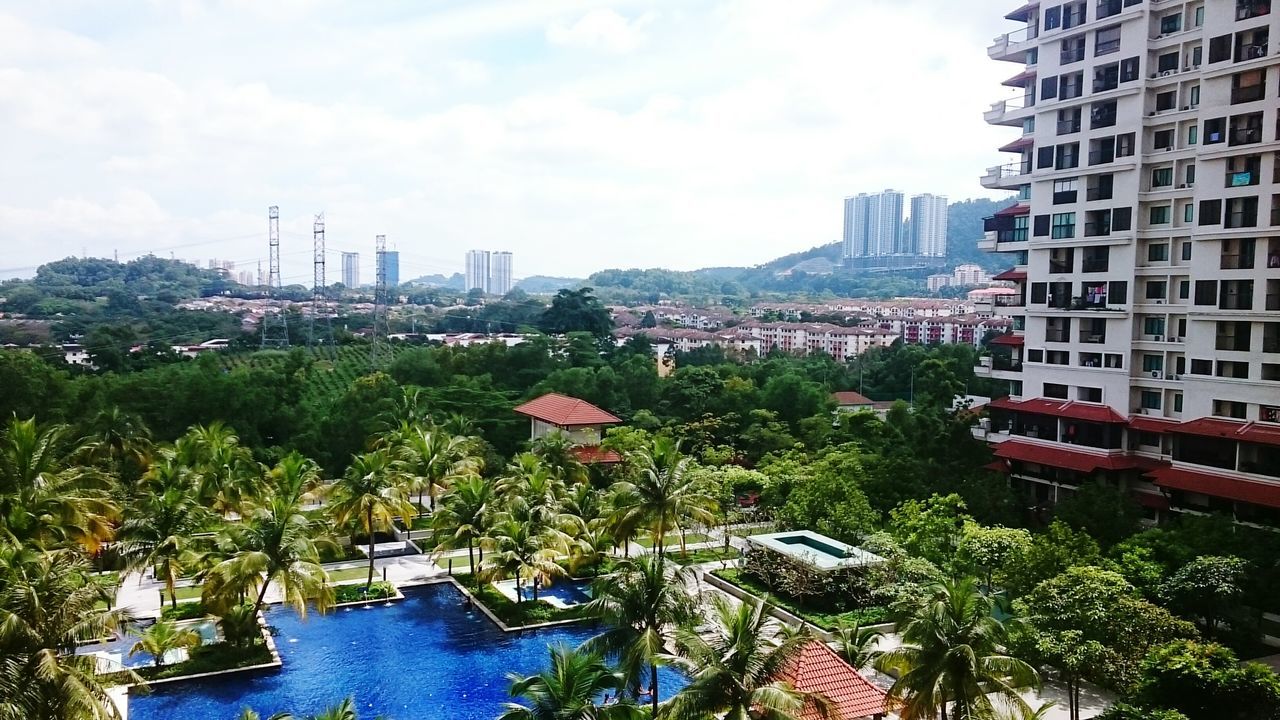 building exterior, architecture, built structure, city, tree, water, sky, growth, cityscape, skyscraper, plant, tower, river, modern, residential building, building, tall - high, day, cloud - sky, travel destinations