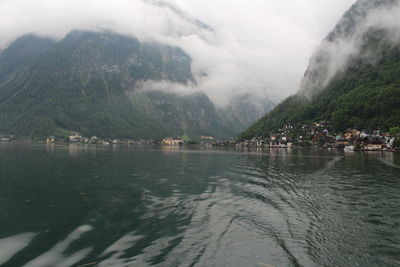 Scenic view of lake by mountains against sky