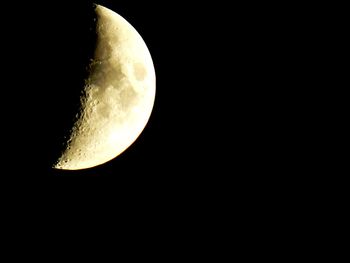 Low angle view of half moon against sky at night