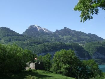 Scenic view of mountains against clear blue sky