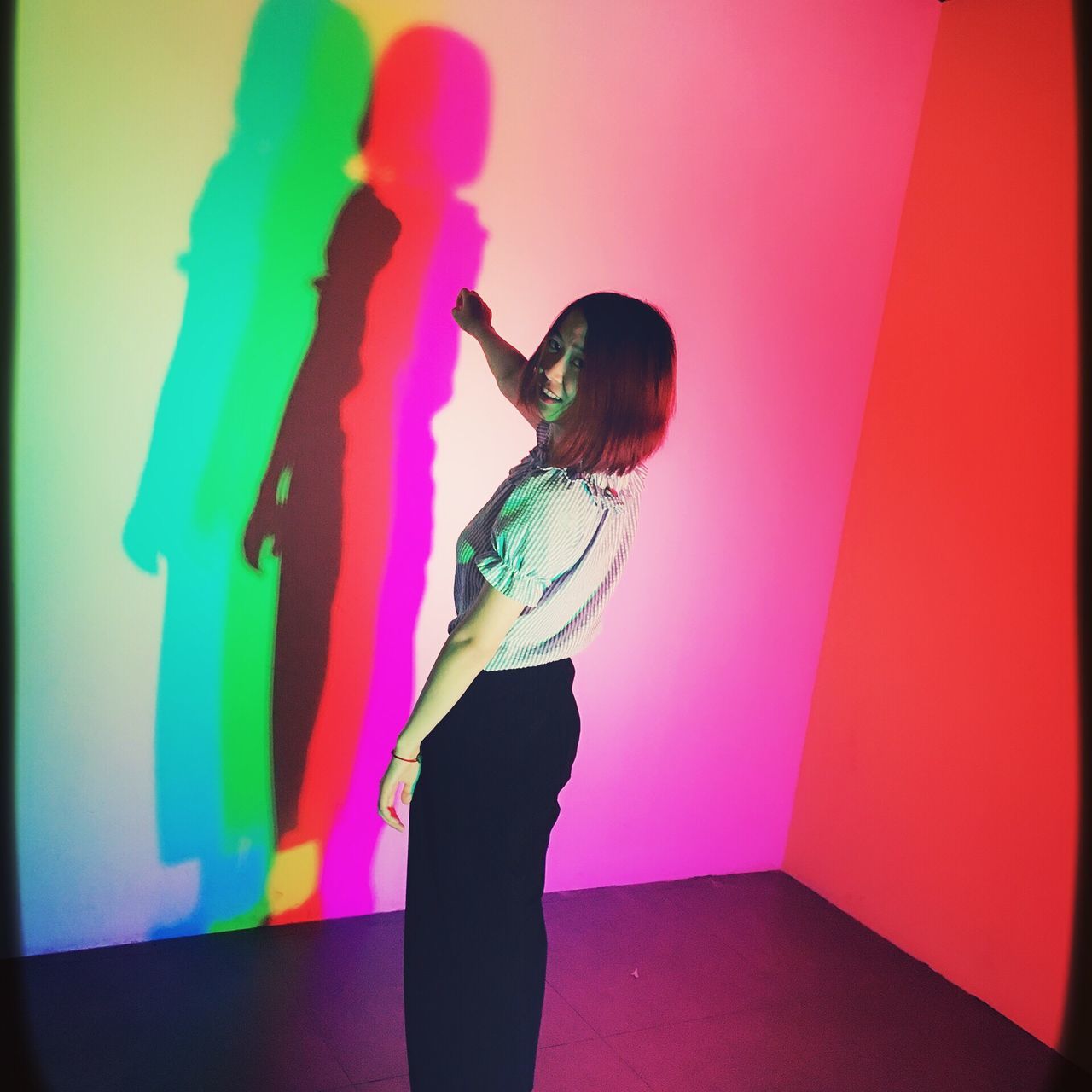 indoors, wall - building feature, multi colored, long hair, person