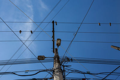 Low angle view of electricity pylon against sky