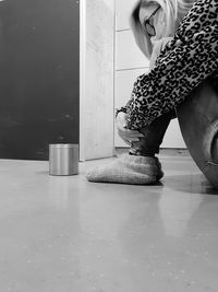 Low section of woman standing on tiled floor