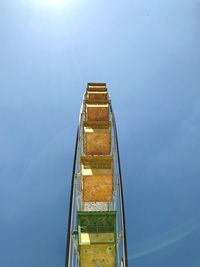 Low angle view of illuminated tower against blue sky