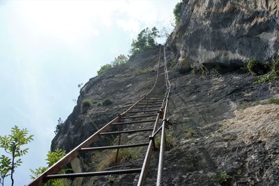 Low angle view of rock formation on mountain against sky