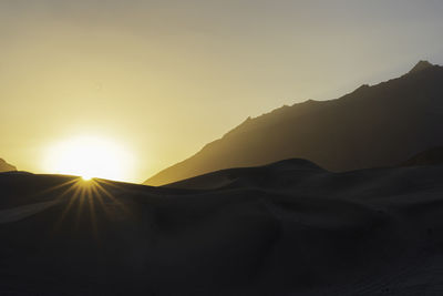 Scenic view of mountains against sky during sunset