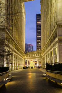 Low angle view of illuminated buildings in city at night