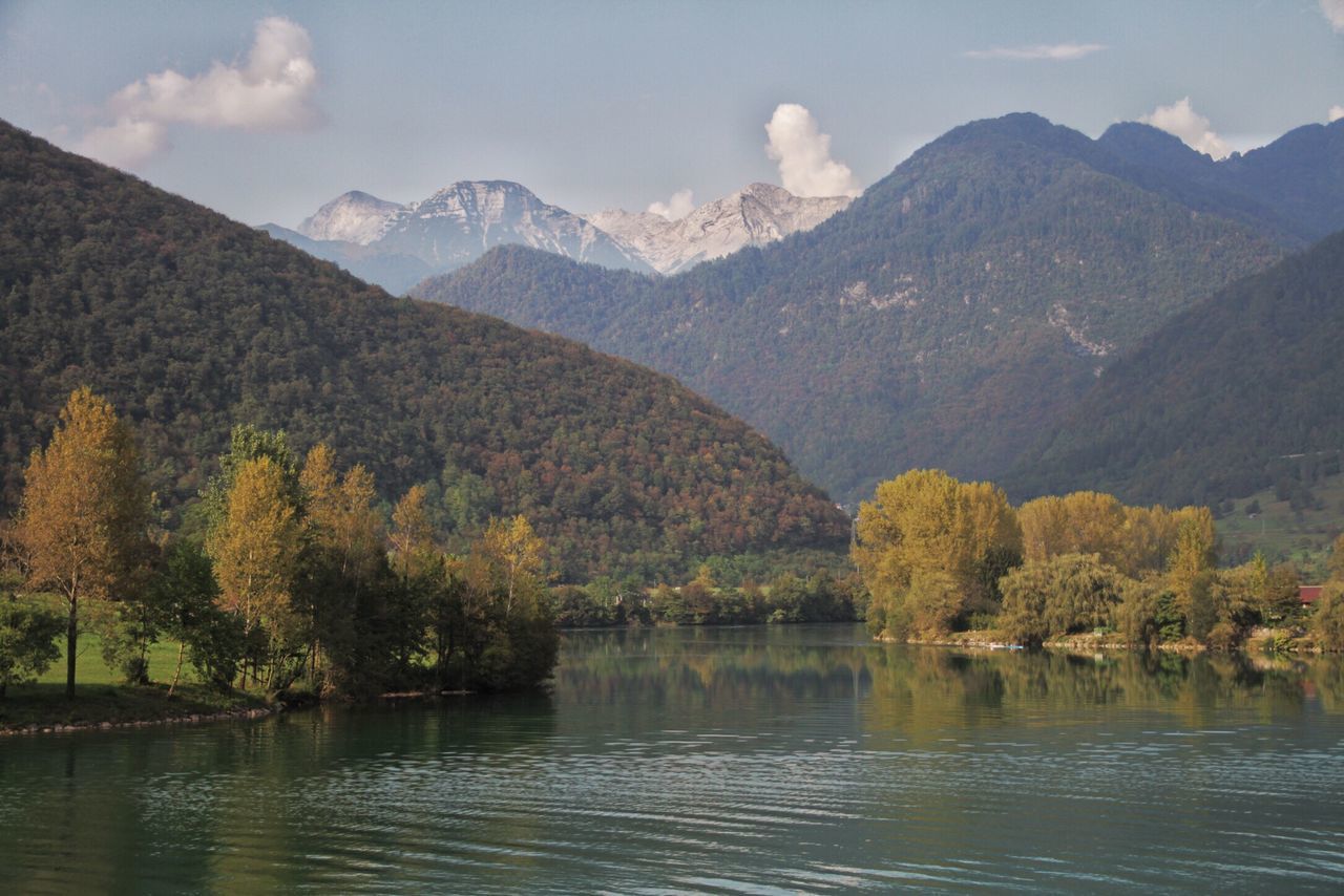 mountain, water, tranquil scene, scenics, mountain range, tranquility, tree, waterfront, beauty in nature, lake, sky, idyllic, nature, majestic, non-urban scene, physical geography, outdoors, geology, rocky mountains, countryside, in front of, green, remote, no people, green color