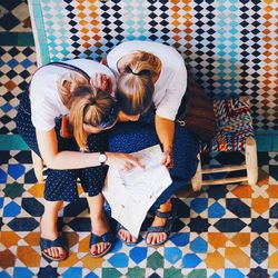 Woman with umbrella on tiled floor