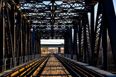 View of railroad tracks along bridge