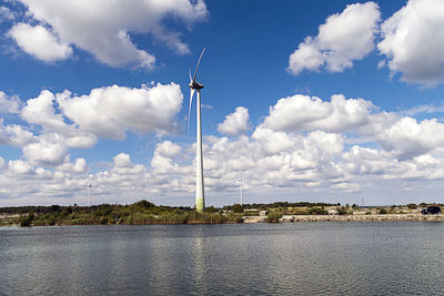 Wind turbines against sky