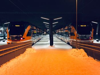 Snow covered railroad station at night during winter