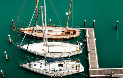 Sailboats moored in sea