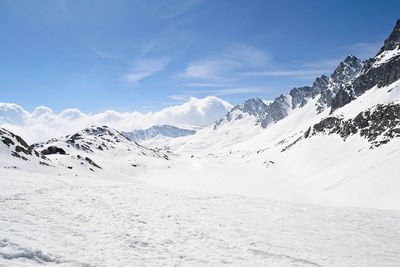 Scenic view of snow covered mountains against sky