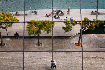 High angle view of people walking on sidewalk in city