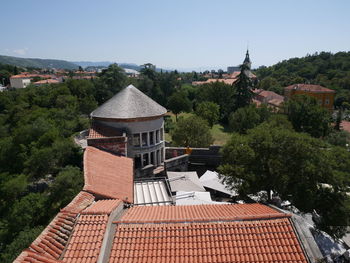 Houses and buildings against clear sky