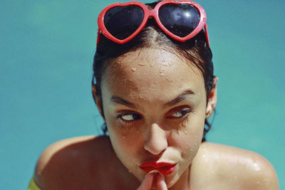 Close-up portrait of young woman in swimming pool