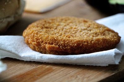 Close-up of chicken wing patty on tissue paper