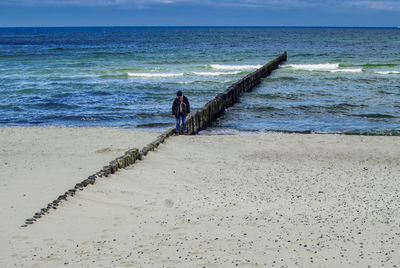 People on beach against sky