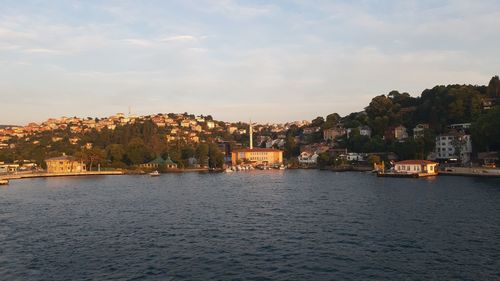 View of townscape by sea against sky