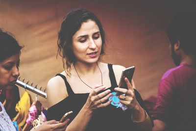 Close-up of young woman using mobile phone at night