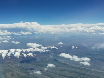 Aerial view of clouds over landscape against sky