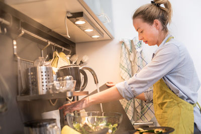 Woman preparing food in kitchen