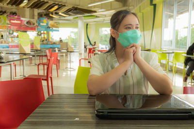 Asian women to work outside office at the food court  the shopping center wearing a mask for safety 