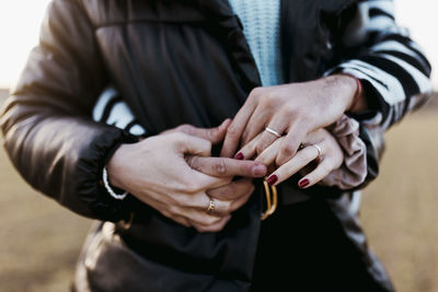 Midsection of man holding hands