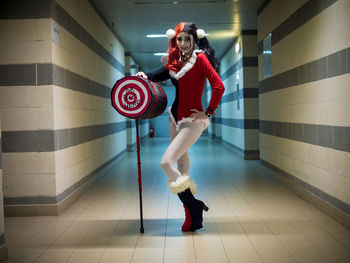 Portrait of smiling young woman in costume standing underground walkway