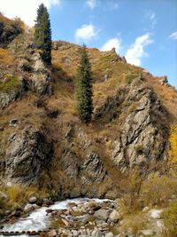 Low angle view of rocks on mountain against sky