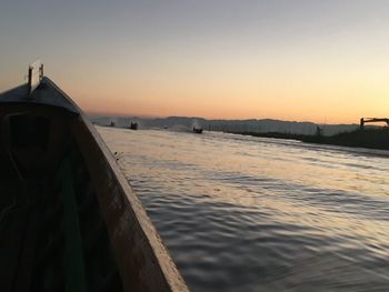 Scenic view of lake against clear sky during sunset