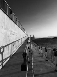 Footbridge against clear sky