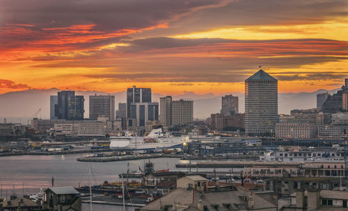 Buildings in city during sunset