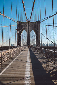 Brooklyn bridge against clear blue sky in city